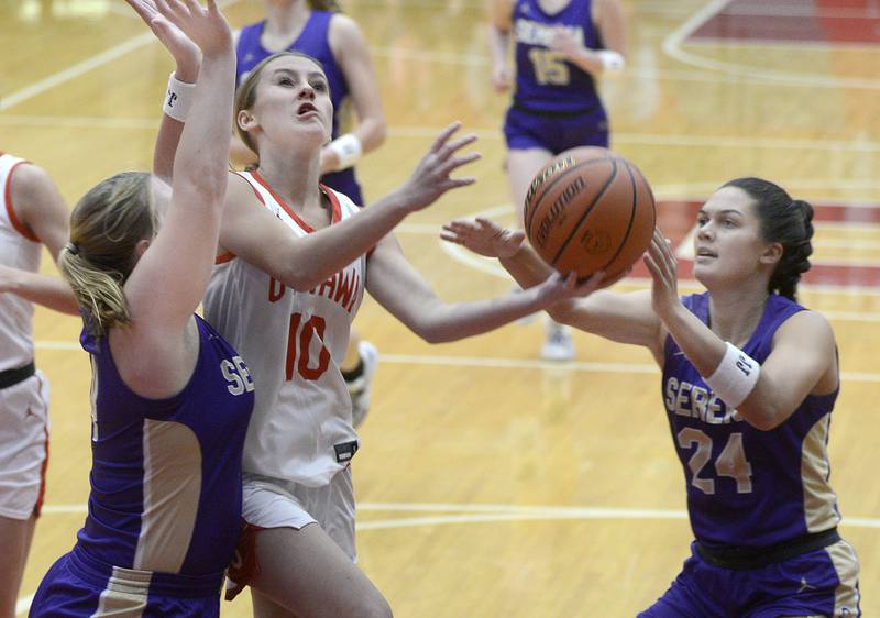 Serena’s Reese Cole and Paisley Twait work to stop Ottawa’s Ella Schmitz as she goes in for a layup in the 1st period on Monday Nov. 28, 2022 at Kingman Gymnasium in Ottawa.