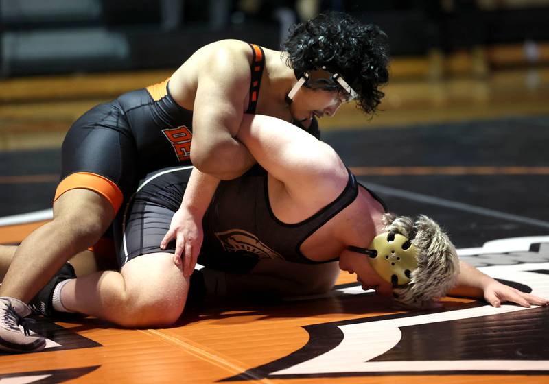 DeKalb’s Elvis Mora tries to turn Sycamore’s Adam Carrick Friday, Jan. 17, 2025, during their 190 pound match at DeKalb High School.
