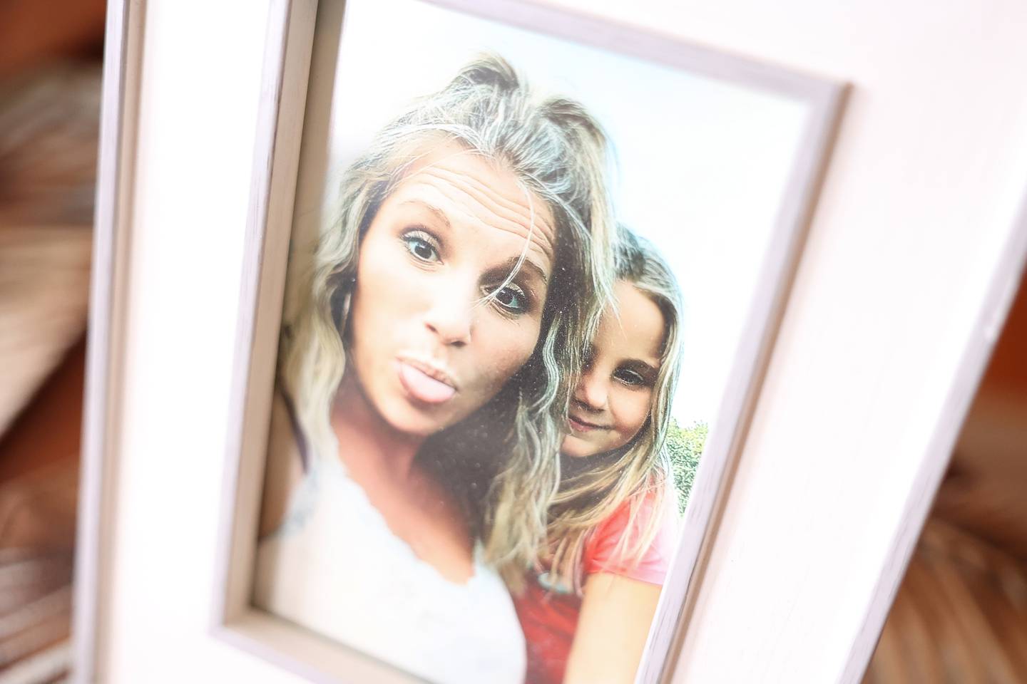 A photo of Melissa Aud-Headlee, known for her fun spirit, and her daughter sit on the table at her parents home in Shorewood on Tuesday, May 14, 2024. Melissa was murdered by her estranged husband on Saturday, May 11, who then killed himself in Joliet.