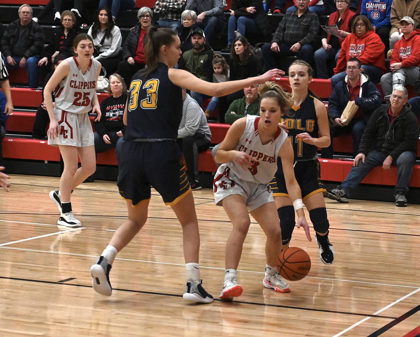 Amboy's Elly Jones (3) drives toward the basket while being defended by Polo's Lindee Poper (33) and Courtney Grobe (11) during the Class 1A Amboy Regional final Friday night.