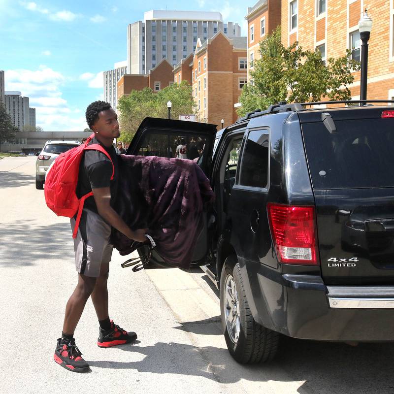 AJ Bowlin, an incoming freshman at Northern Illinois University from Homewood, unpacks his car Wednesday, Aug. 21, 2024, as he moves into Patterson Hall during the first of two move-in days for new students at NIU in Dekalb.