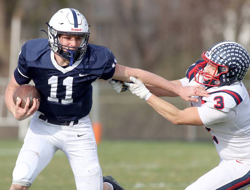 Cary-Grove’s Peyton Seaburg evades Belvidere North’s Gabriel Sillinpaa in IHSA Class 6A quarterfinal playoff football action on Saturday, Nov. 16, 2024, at Al Bohrer Field on the campus of Cary-Grove High School in Cary.