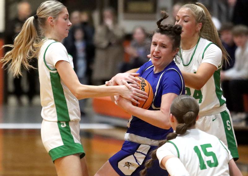 Crystal Lake South’s Makena Cleary, left, and Gracey LePage, right, double team Geneva’s Keira McCann in girls IHSA Class 3A Sectional Championship basketball on Thursday, Feb. 26, 2026, at Crystal Lake Central High School in Crystal Lake.