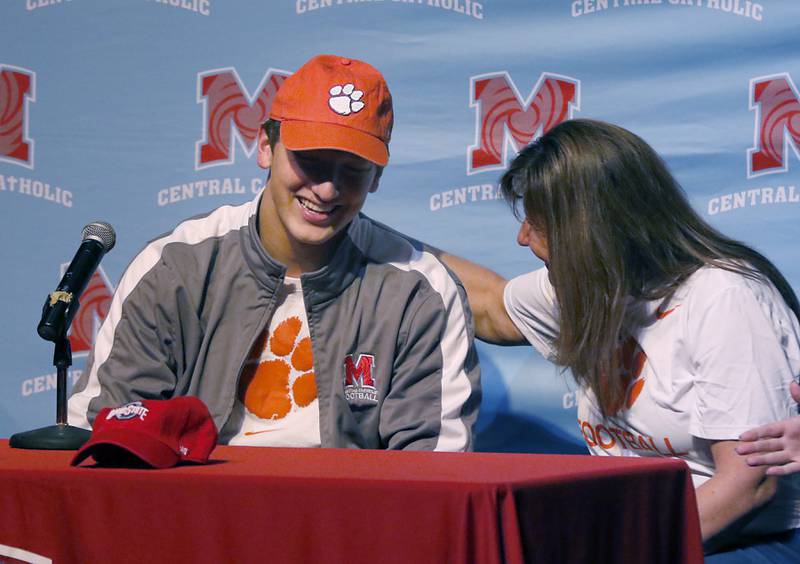 Christian Bentancur receives a pat on the back from his mother, Elizabeth, after he announced Friday, Jan. 13, 2023, that he will attend Clemson University to play Division I football, at Marian Central High School. Bentancur, a highly recruited tight-end, narrowed his section down to Clemson from his final three colleges. The other two colleges were Ohio State and Oregon universities.