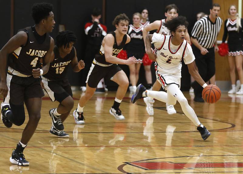Huntley's Omare Segarra pushes the ball up the court against the Jacobs defense during a Fox Valley Conference boys basketball game Tuesday, Jan. 24, 2023, at Huntley High School.