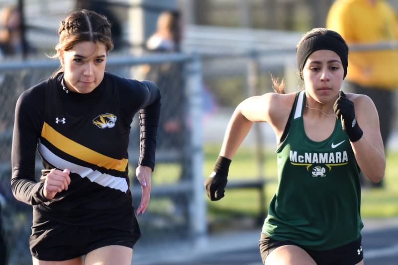 Herscher's Kelly O'Connor, left, and Bishop McNamara's Ana Franceschini run the 800 meters at the Herscher Invite Friday, May 1, 2026.