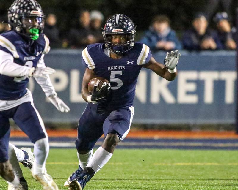 IC Catholic Prep's Aaron Harvey (5) runs after a cut back during Class 4A third round playoff football game between St Laurence at IC Catholic Prep.  Nov 11, 2023.