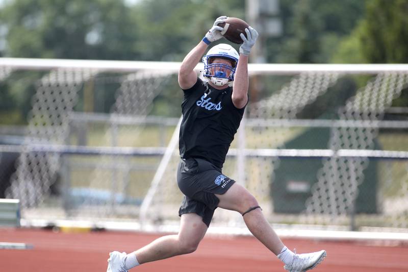 St. Charles North’s Jake Furtney catches a pass during a 7 on 7 tournament at St. Charles North High School on Thursday, June 30, 2022.