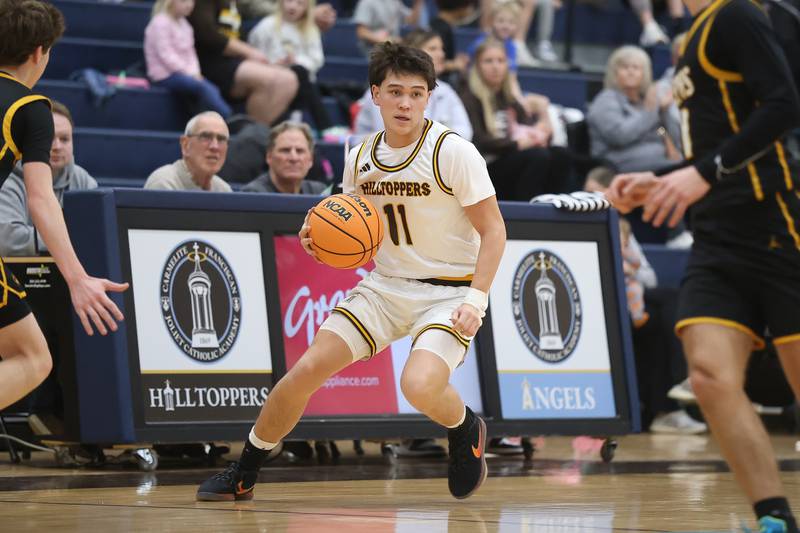 Joliet Catholic’s Charlie Czerkies looks for a play against Elmwood Park in the Class 3A Joliet Catholic Regional semifinal game on Wednesday, Feb. 25, 2026 in Joliet.