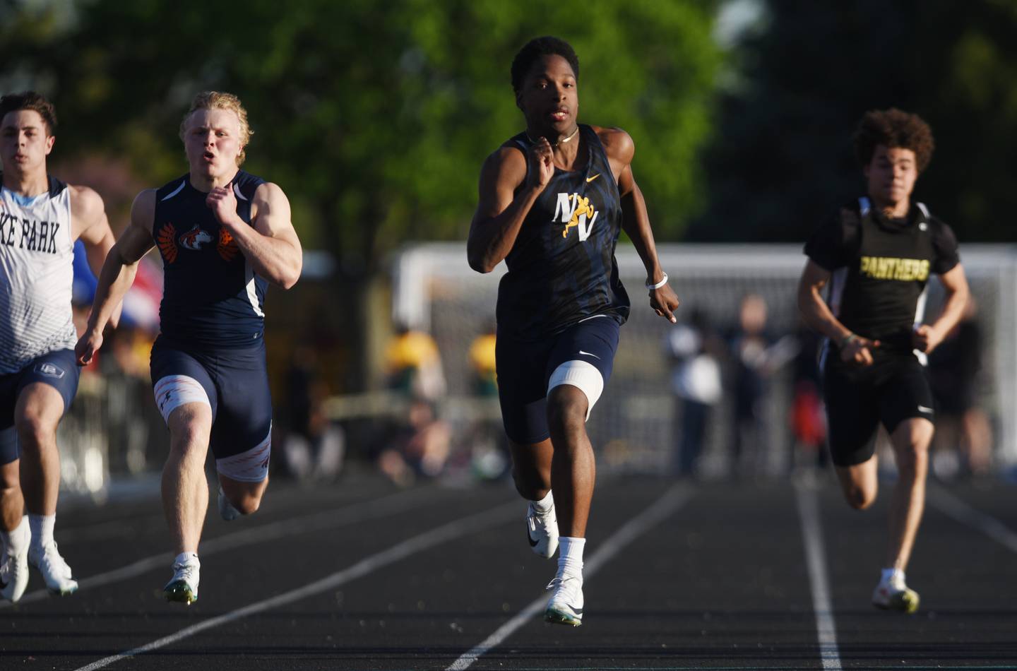 Neuqua Valley’s Daniel Robinson, middle, sprints to the finish as he wins the 100-meter dash during the DuPage County boys track and field meet at Wheaton Warrenville South High School on Friday, May 9, 2025 in Wheaton.