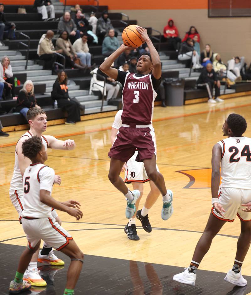 Wheaton Academy's Donell Ausley Jr. shoots between four DeKalb defenders during their game Wednesday, Jan. 14, 2026, at DeKalb High School.