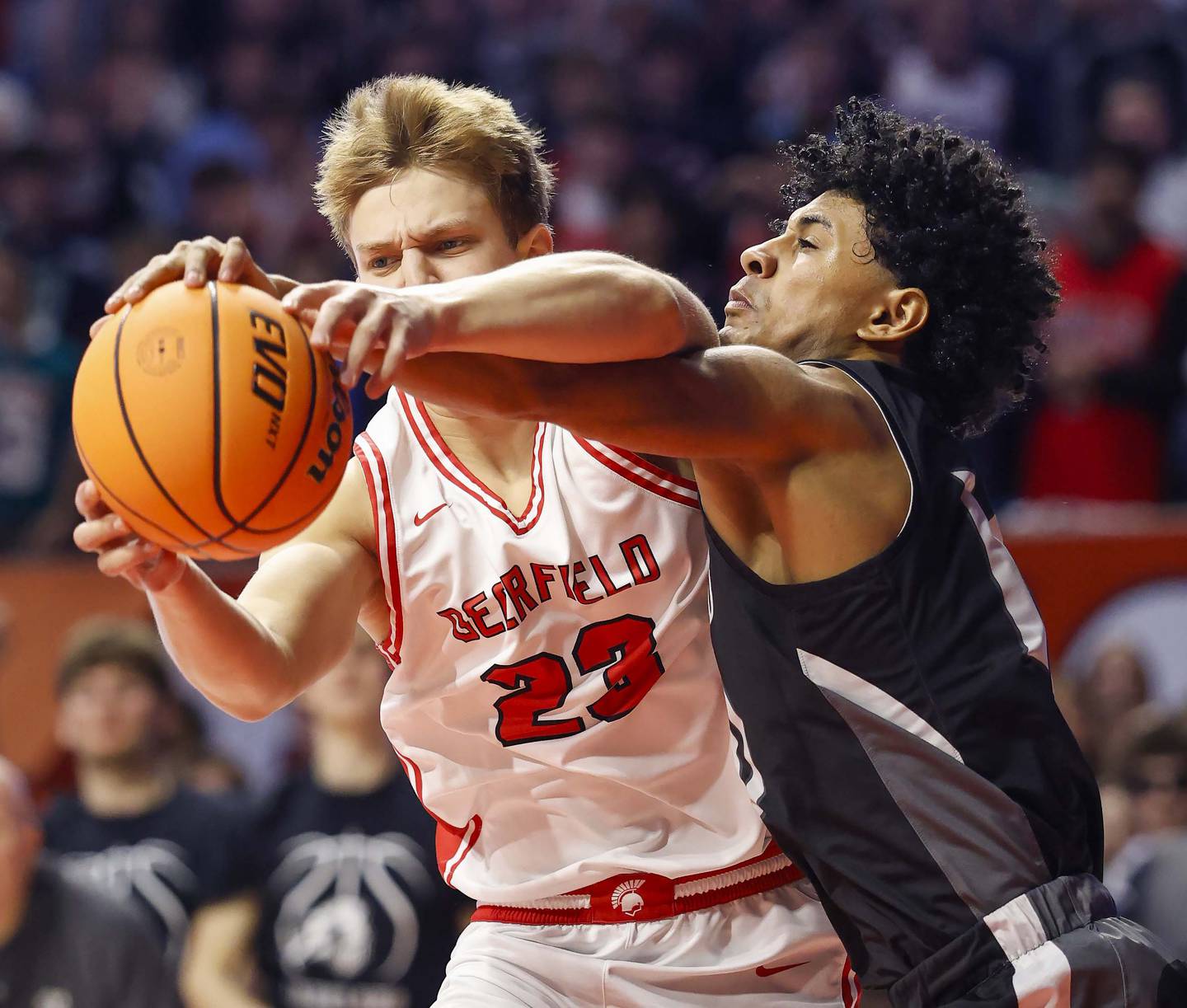 Deerfield's Chase Arenberg (23) battles Kaneland's Jalen Carter (10) for a rebound during the IHSA Class 3A boys basketball state semifinal Friday, March 13, 2026 at the State Farm Center in Champaign.
