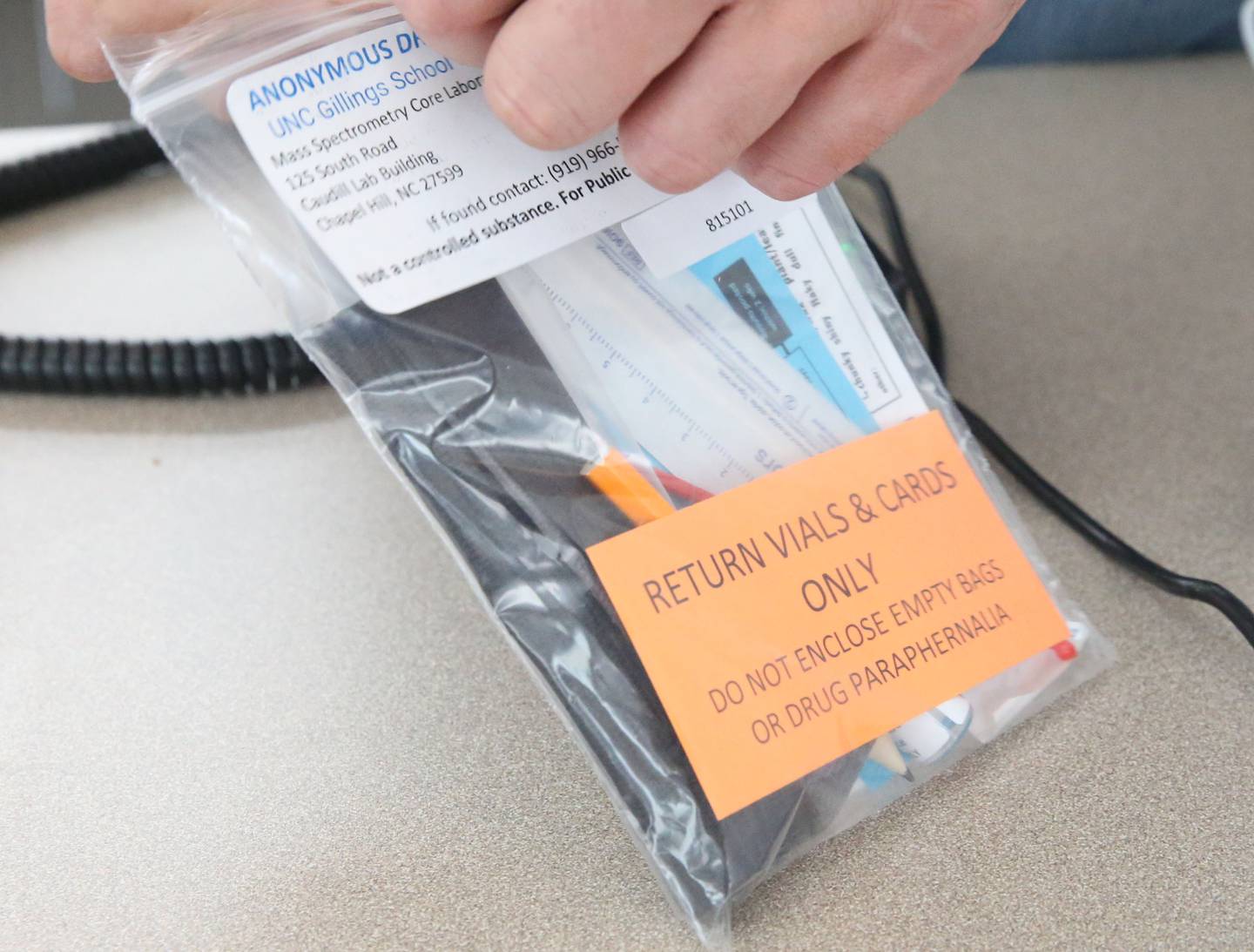 Matt Rowlee, director of outreach and drug technician at Perfectly Flawed uses a drug paraphernalia kit before analyzing a spectrometer used to identify both legal and illegal drugs and their components on Thursday, Oct. 16, 2025 at their office in La Salle.