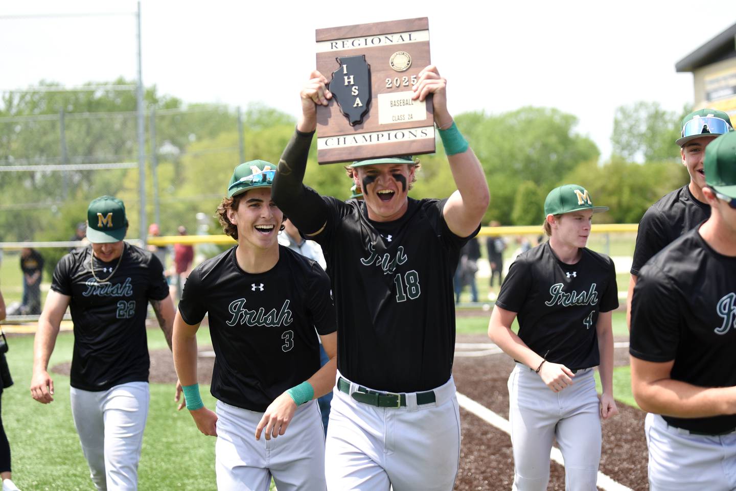 Bishop McNamara's Jacob Lotz hoists the Class 2A Herscher Regional championship after McNamara's 5-0 win over Herscher in the championship game Saturday, May 24, 2025.