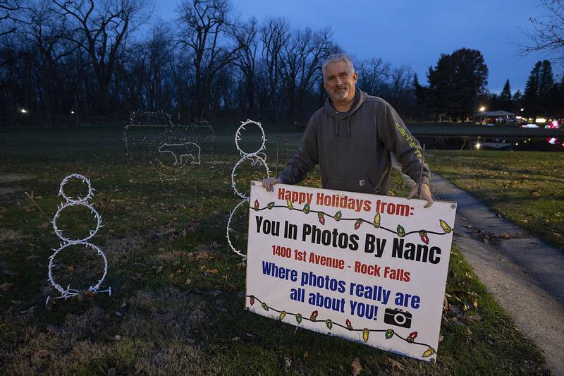 Duffy Dorner puts up a sign Tuesday, Nov. 26, 2024, for a lighted display in Rock Falls.