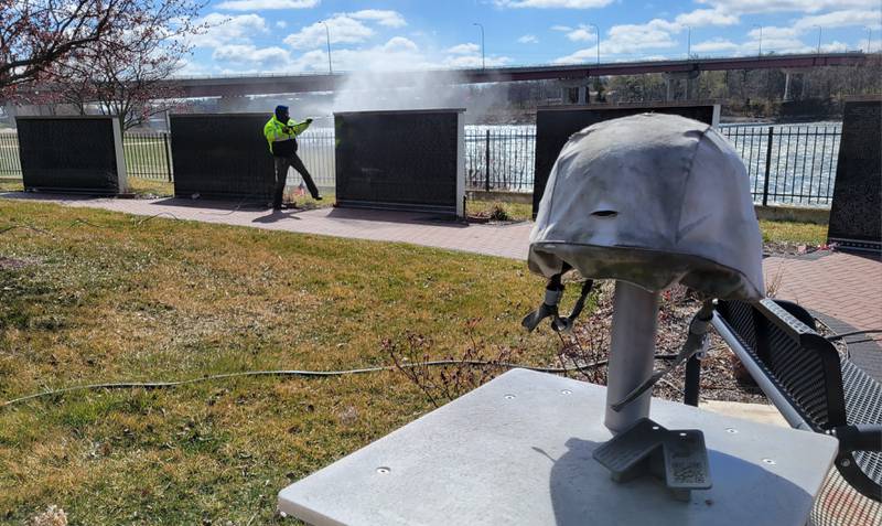 Laborers Local 393 volunteer Thomas Simon sprays the grime off of the Middle East Conflicts Memorial Wall in Marseilles on Wednesday.