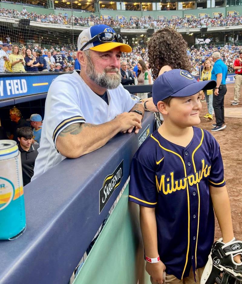 Danny Kolb and his son, Korbyn, 8, take in the 25th anniversary of the Milwaukee Brewers stadium from the Brewers dugout on Friday, July 25. Korbyn was born seven years after his dad retired from baseball and Danny said he wanted to give him a taste of the experience he lived as a player.