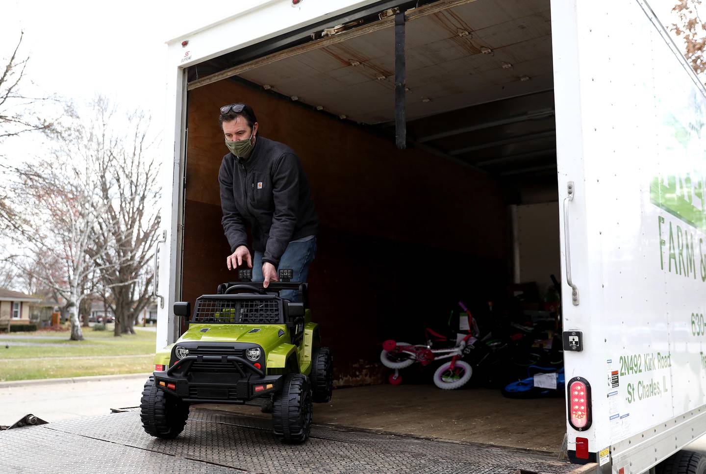 Tom Stopka unloads some of the toys he and his wife, Jen,  collected for donation to the Tri-City Salvation Army in honor of their son, Tommy