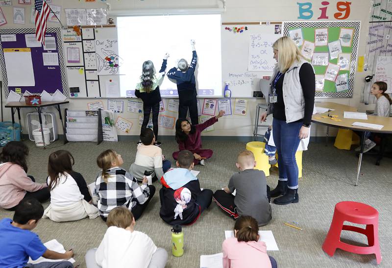 Fifth-grade teacher Jennifer Hollabaugh explains how to solve a math problem Wednesday, Oct, 26, 2022, to the students that Hollabaugh and Jim Garvalia co-teach at Conley Elementary School, 750 Dr. John Burkey Drive in Algonquin.