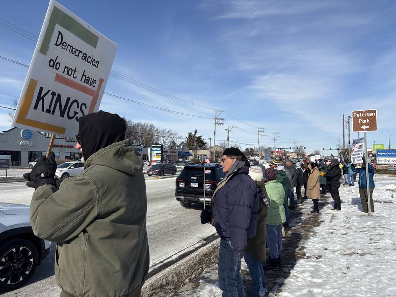 Protesters hold signs at a protest in McHenry Feb. 1, 2026.