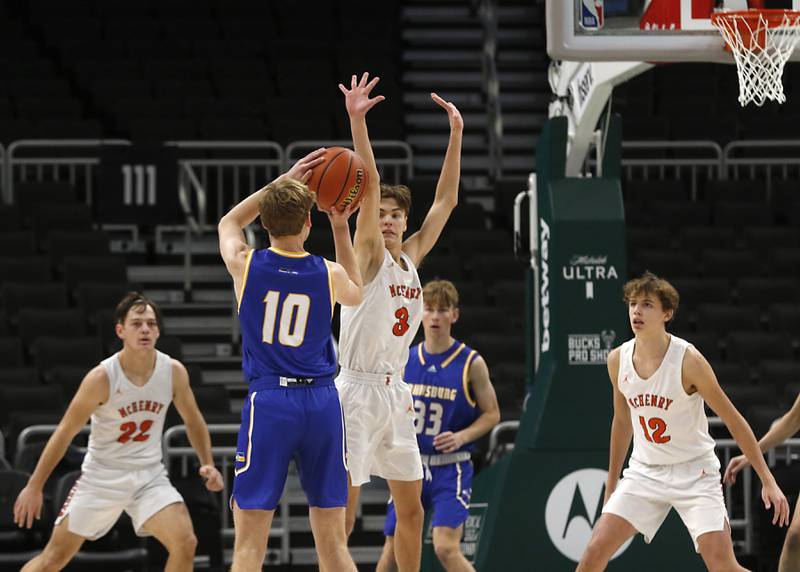 Johnsburg's Ben Person tries to shot the ball over McHenry's Zachary Maness during a non-conference basketball game Sunday, Nov. 27, 2022, between Johnsburg and McHenry at Fiserv Forum in Milwaukee.