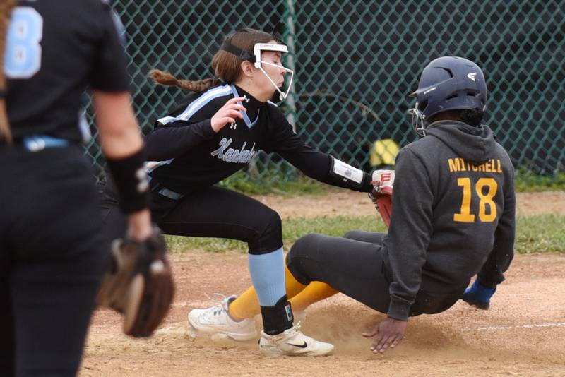 Kankakee's Adleigh Cunningham, left, tags out Thornwood's Armani Mitchell at third base during a game at Kankakee Thursday, Apruil 17, 2025.