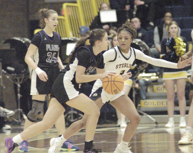 Plano's Lizbeth Salgado drives the ball past Sterling's elali Amankwa. The Sterling Golden Warriors faced off against Plano Lady Reapers in an IHSA 3A Regional girls final at Musgrove Fieldhouse in Sterling on February 20, 2025. Sterling won the game 70-38.