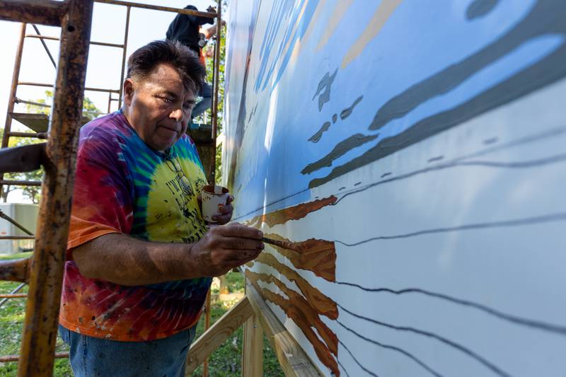 Doug Haffner of the Walldogs paints log on the Streator mural on Thursday, Sept. 11, 2025 at City Park in Streator.