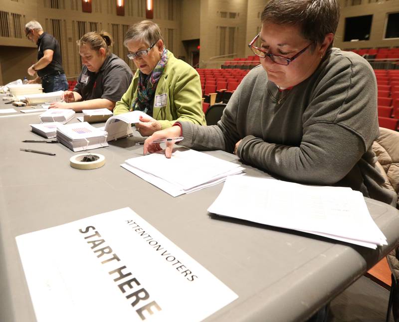 Election judges Joleen Gumuski, Gaye Abrahams, and Deb Baltikauski run the check in table at Hall High School on Tuesday, Nov. 8, 2022 in Spring Valley.