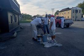 Phase 2 of the community beautification project priming and painting.