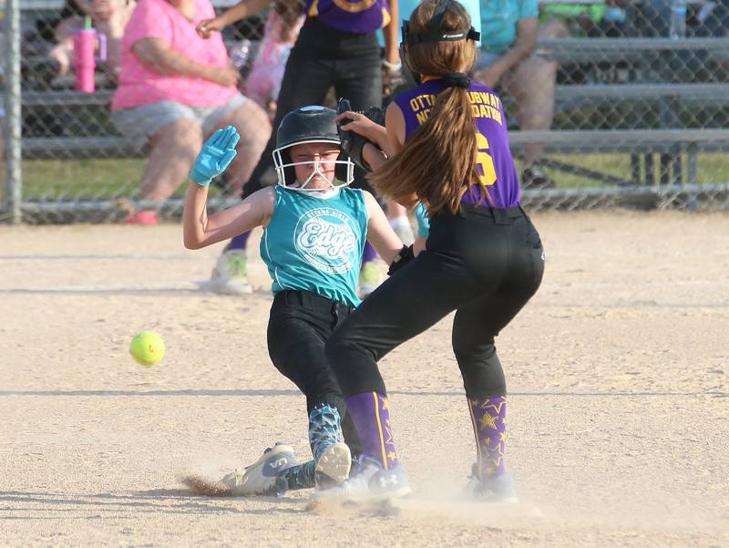 Edge's Eden Weems slides in safely to second base as Warrior's Alexis Samaniego watches the ball come to the bag during the Ottawa Girls Fastpitch Association 11U City Championship on Wednesday July 2, 2025 at Peck Park in Ottawa.