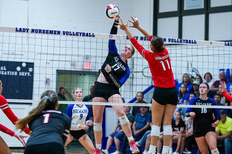 Newark’s Zoey Carlson (17) goes up for a kill attempt against Aurora Christian's Gabriella Cotto (11) during a non-conference match at Newark High School on Tuesday, Sept. 9, 2025.
