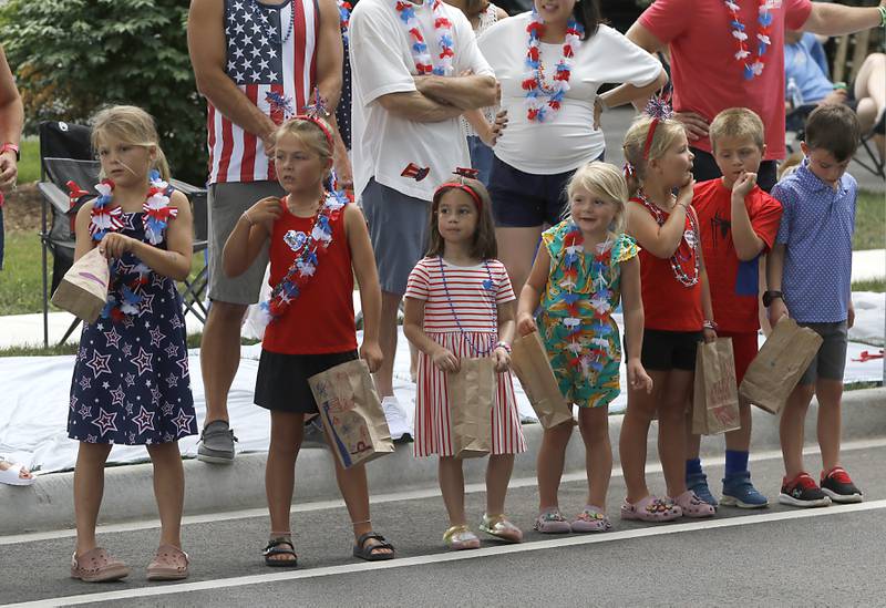 Children are ready to catch candy on Sunday, July 6, 2024, during Crystal Lake’s annual Independence Day Parade on Dole Avenue in Crystal Lake.