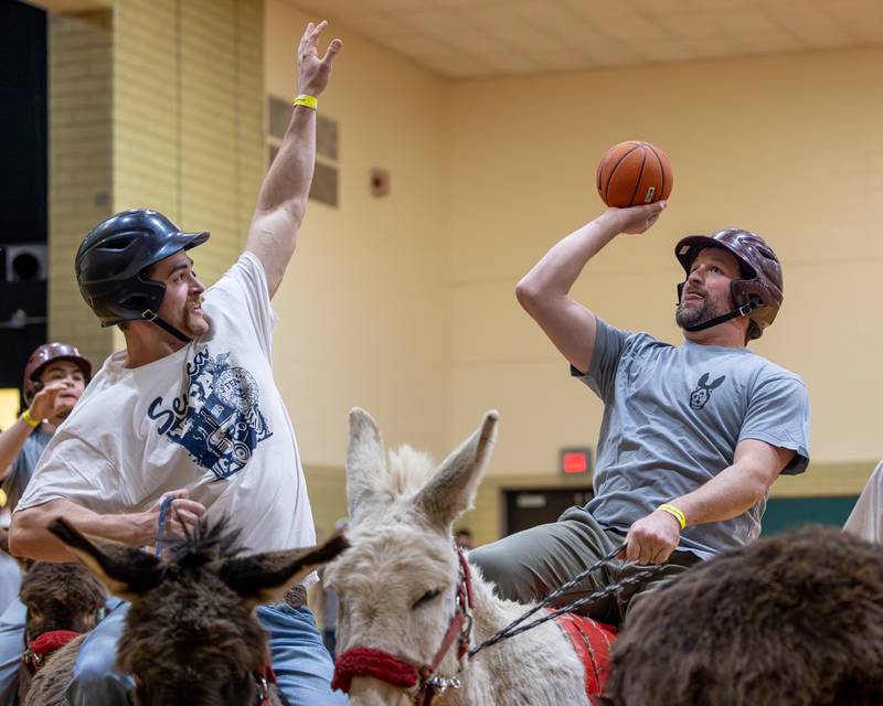 Member of the 'Village Church' team shoots midrange shot over member of 'Seneca FFA Officers and Alumni' in game of Donkey Basketball on Saturday, Feb. 7, 2026 at Seneca High School West Campus in Seneca.