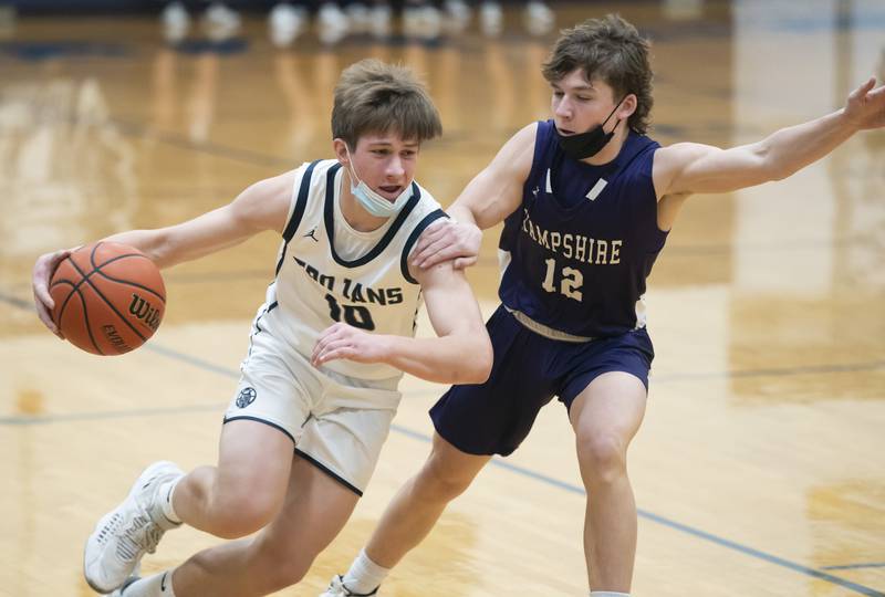 Hampshire's Nicholas Louis gets a hand on Cary-Grove's Jake Hornok during their game on Tuesday, January 25, 2022 at Cary-Grove High School in Cary.
