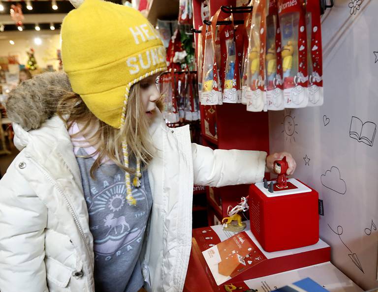 Emmy Dickman, 3, of Crystal Lake plays with a Toniebox while she shops fro Christmas presents for her cousins on Monday, Dec. 19, 2022, at Marvin's Toy Store in Crystal Lake. This year, Marvin's most popular items are  construction kits and screen-less-technology toys, including the Toniebox, that reads stories to children.