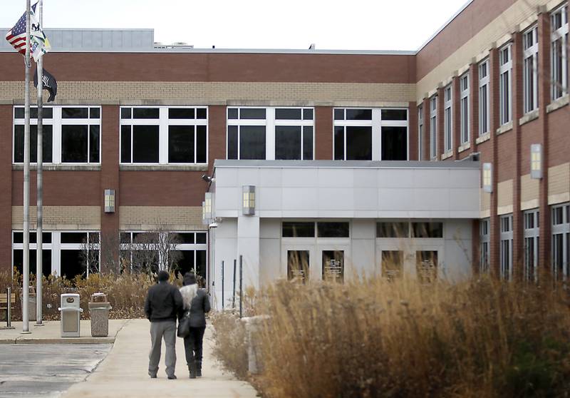 People walk towards the McHenry County Administration Building in Woodstock on Monday, Nov. 20, 2023. The McHenry County Board is schedule to vote on the county budget this evening.