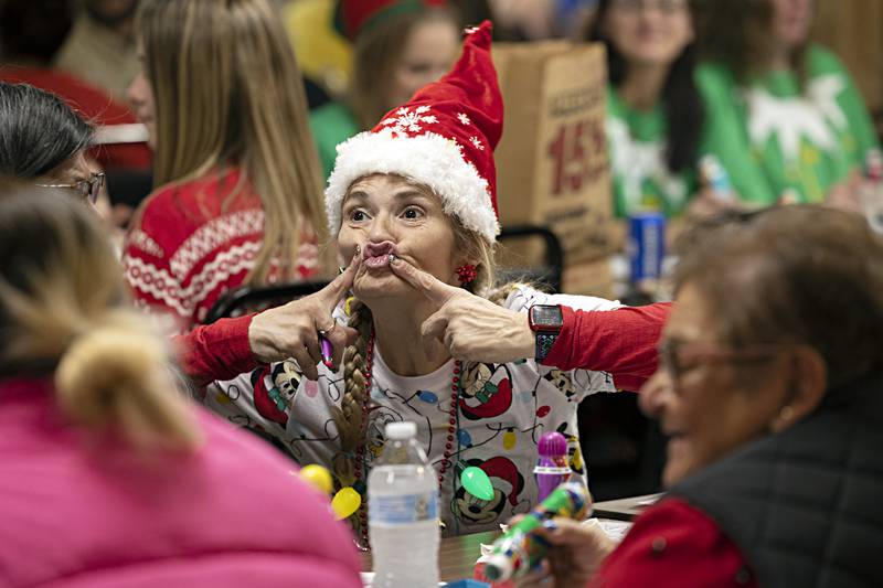 Heather Nickle gestures with friends while enjoying the BINGO fun Thursday, Nov. 16, 2023.