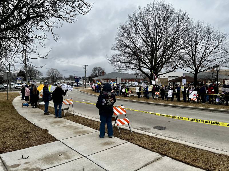 A crowd gathers in Sterling, Illinois, to protest President Donald Trump and his administration on Friday, March 7, 2025.