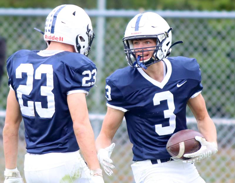 Cary-Grove’s Ty Tenopir, right, is greeted by Lance Moore as they celebrate a Tenopir touchdown against Sycamore in IHSA football Class 5A first-round playoff action at Al Bohrer Field on the campus of Cary-Grove High School in Cary on Saturday, November 1, 2025.