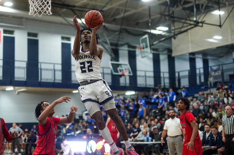 Oswego East's Jehvion Starwood (22) drives to the hoop against West Aurora during a basketball game at Oswego High School on Friday, Feb 2, 2024.