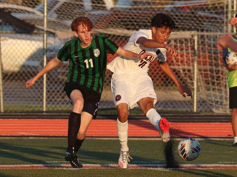 DeKalb's Jorge Correa kicks the ball away from the defense of St. Edward's Kaden Bergholt Thursday, Aug. 28, 2025, during their game in the Barb Cup tournament at DeKalb High School.