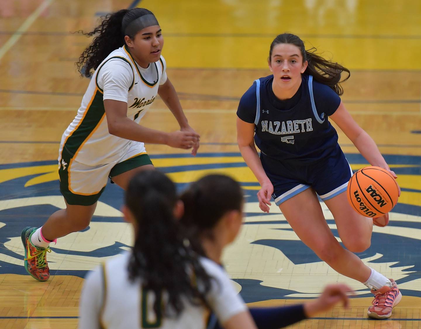 Nazareth’s Sophia Towne drives past Waubonsie Valley’s Arianna Garcia-Evans (left) during the Class 4A Lyons Supersectional game on March 2, 2026 at Lyons Township High School in LaGrange.