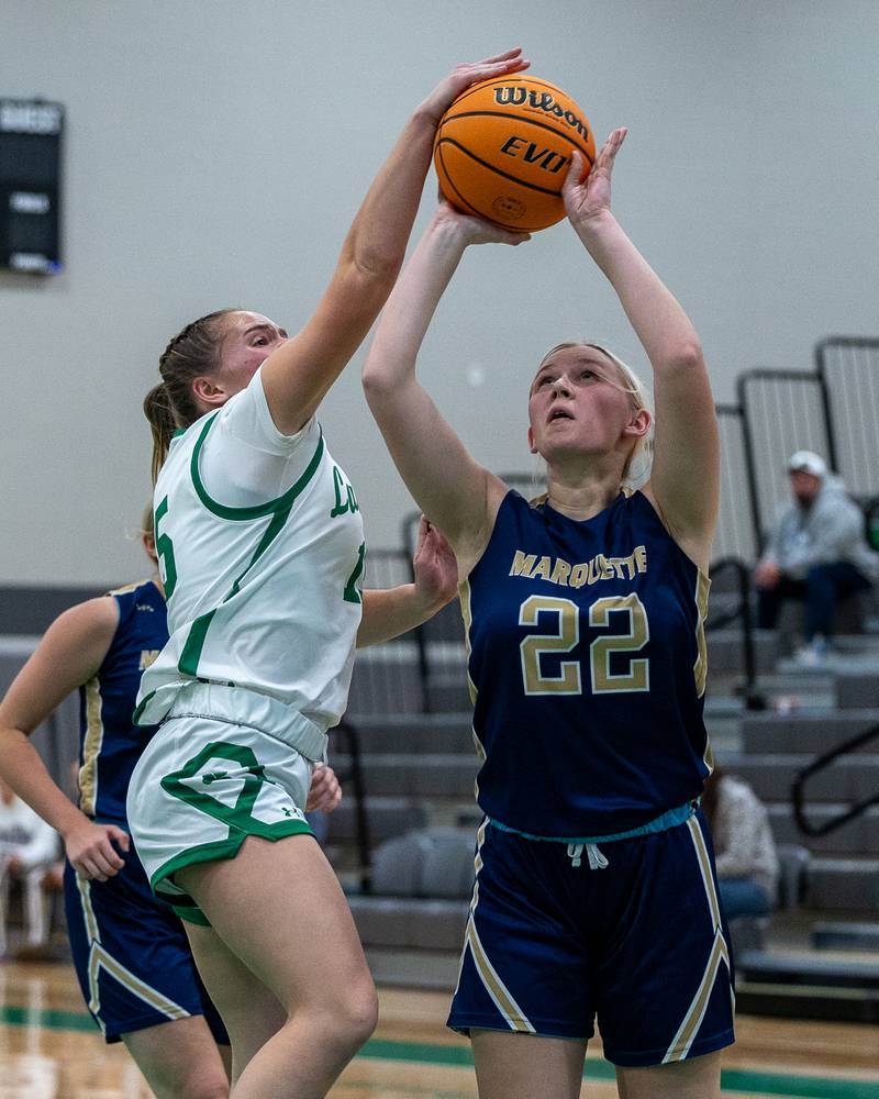Seneca's Kylee Rowley (15) blocks a shot attempt by Marquette's Navaeh Corcoran (22) on Monday, Nov. 17, 2025, during the opening night of the Falcon-Irish Thanksgiving Tournament at Seneca.