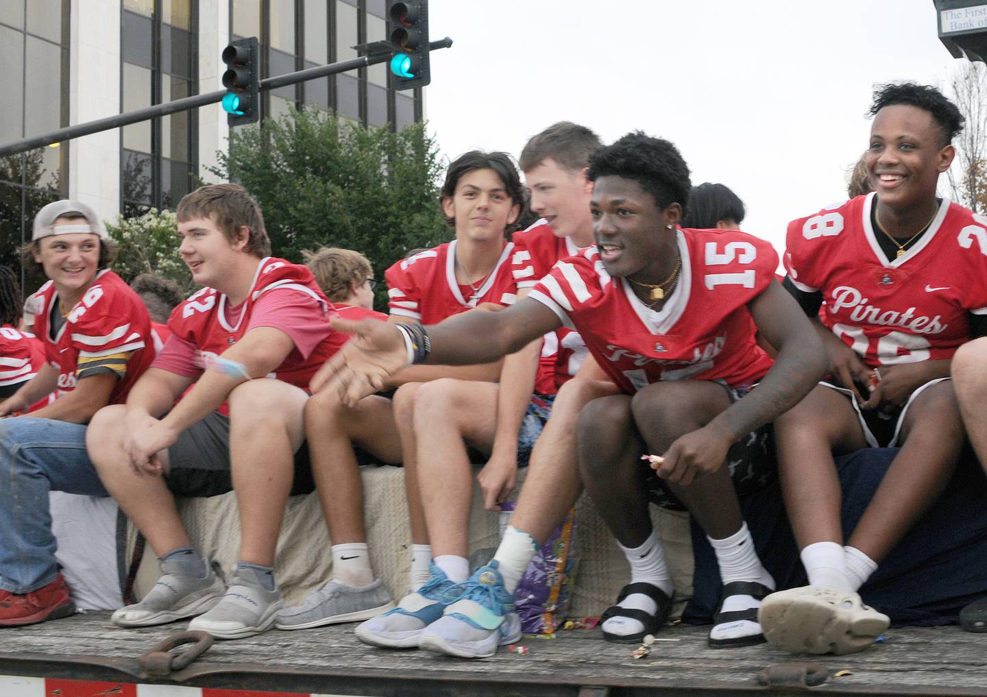 The Ottawa High School varsity football team tosses candy to the crowd Wednesday, Sept. 21, 2022, along LaSalle Street in Ottawa during the school’s homecoming parade.