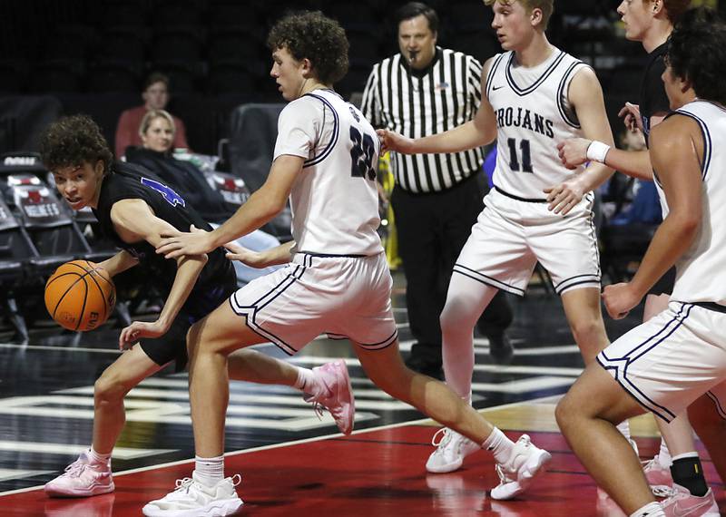 Burlington Central's Ryan Carpenter brings a rebound in the pant out as he is guarded by Cary-Grove's Adam Bauer during a Fox Valley Conference basketball game  on Tuesday, Jan. 14, 2025, at Now Arena in Hoffman Estates.