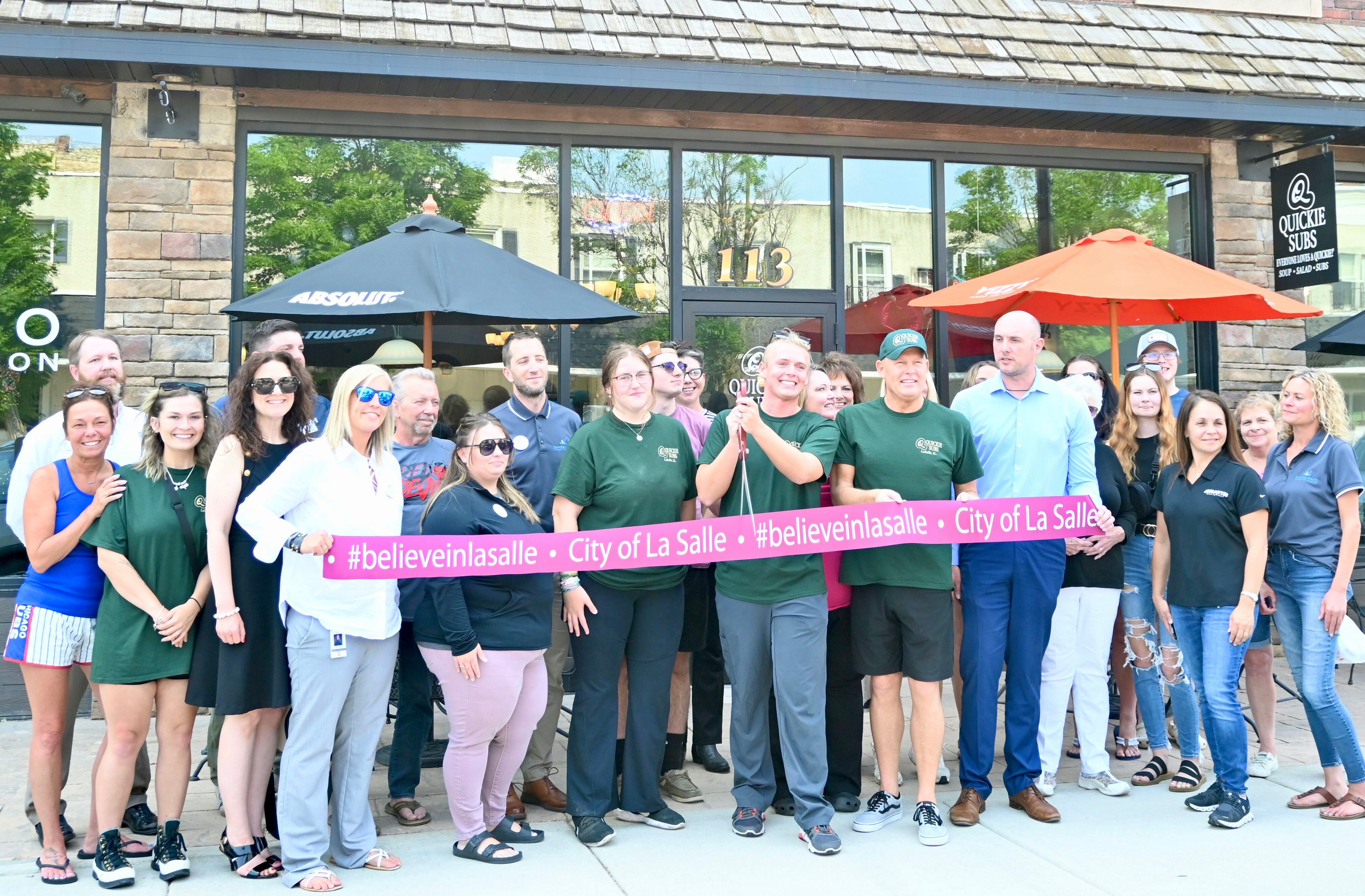 Quickie Subs owner Nick Ross gets ready to cut the ribbon next to his husband and owner Mark Ross during the ceremony held at 4 p.m. Wednesday June 14.