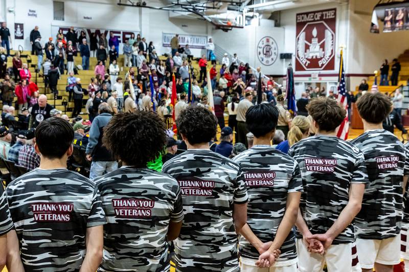 The LTHS varsity basketball team stands as veterans are recognized during Lockport Township High School’s 11th Annual Veteran Night Celebration Ceremony on Jan. 23, 2026.