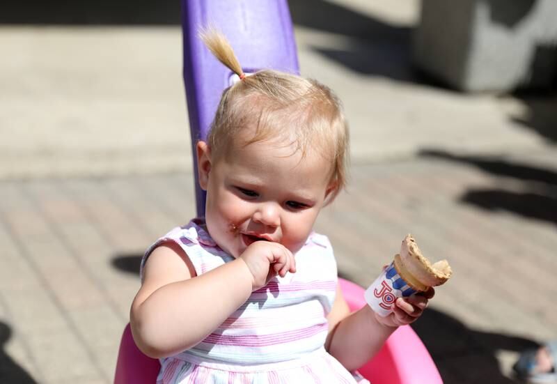 One-year-old Joy Swanson enjoys a cone outside the Batavia Creamery on Thursday, June 6, 2024. Batavia Police personnel were on-hand handing out coupons for free scoops of ice cream.