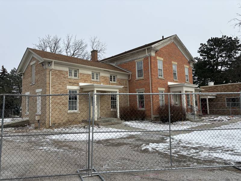 The Crystal Lake Academy Building pictured with demolition fencing Dec. 30, 2025.